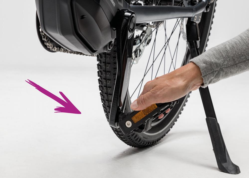 Flipping down pedals on your Charge electric bike