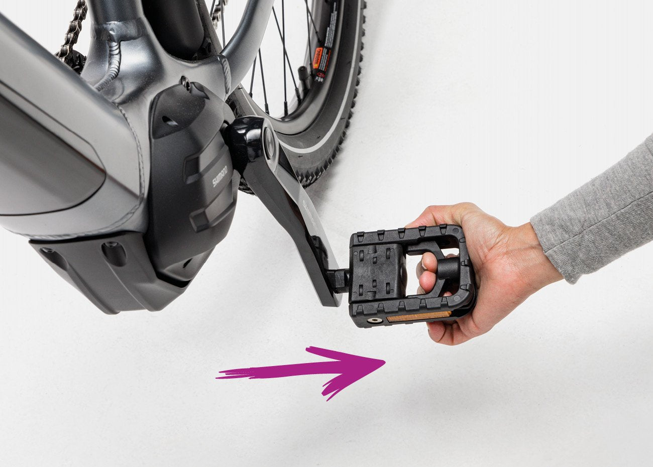 Pull lever to flip pedal closed on electric off-road bike